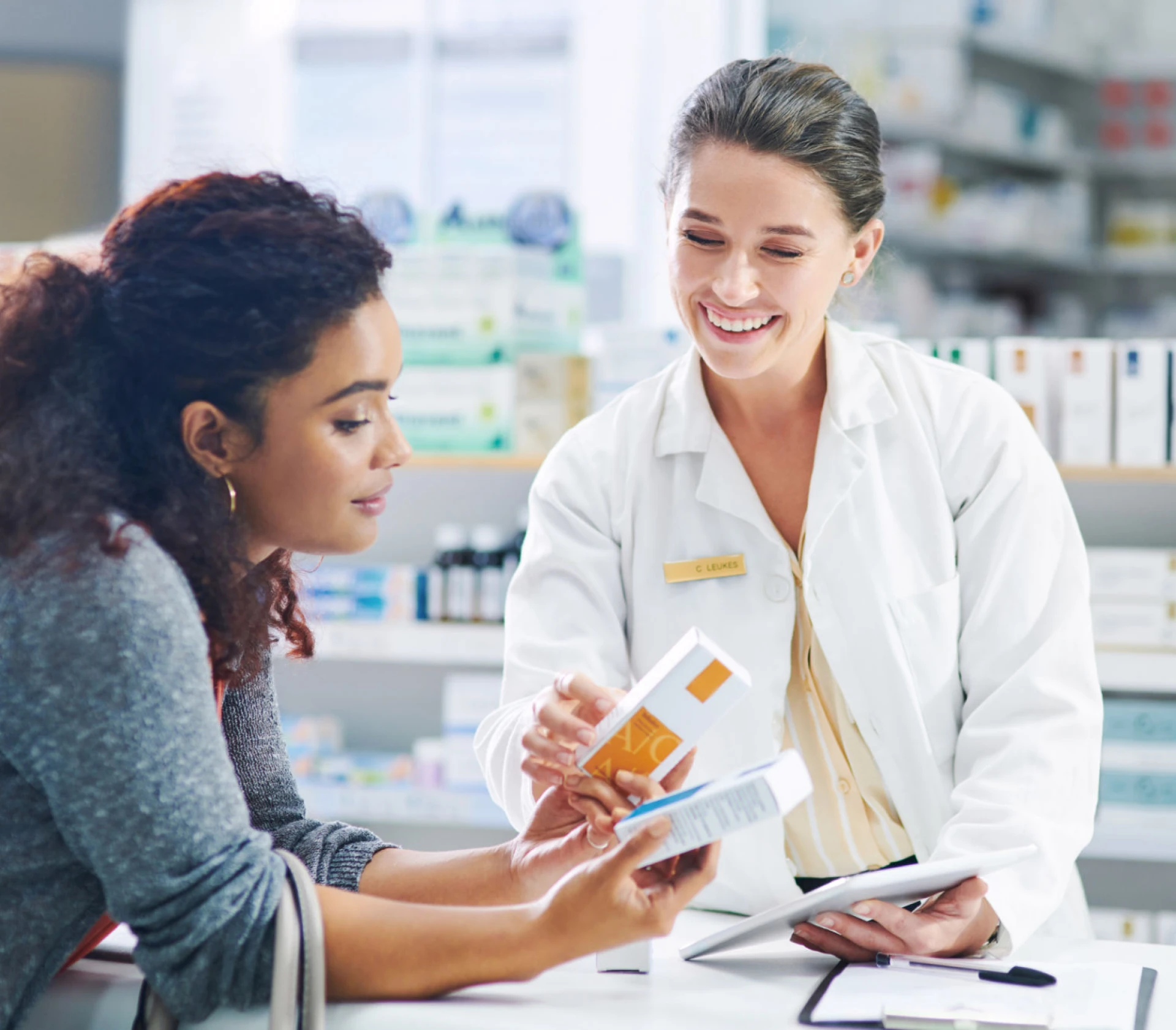 Friendly pharmacist helping customer with medicine