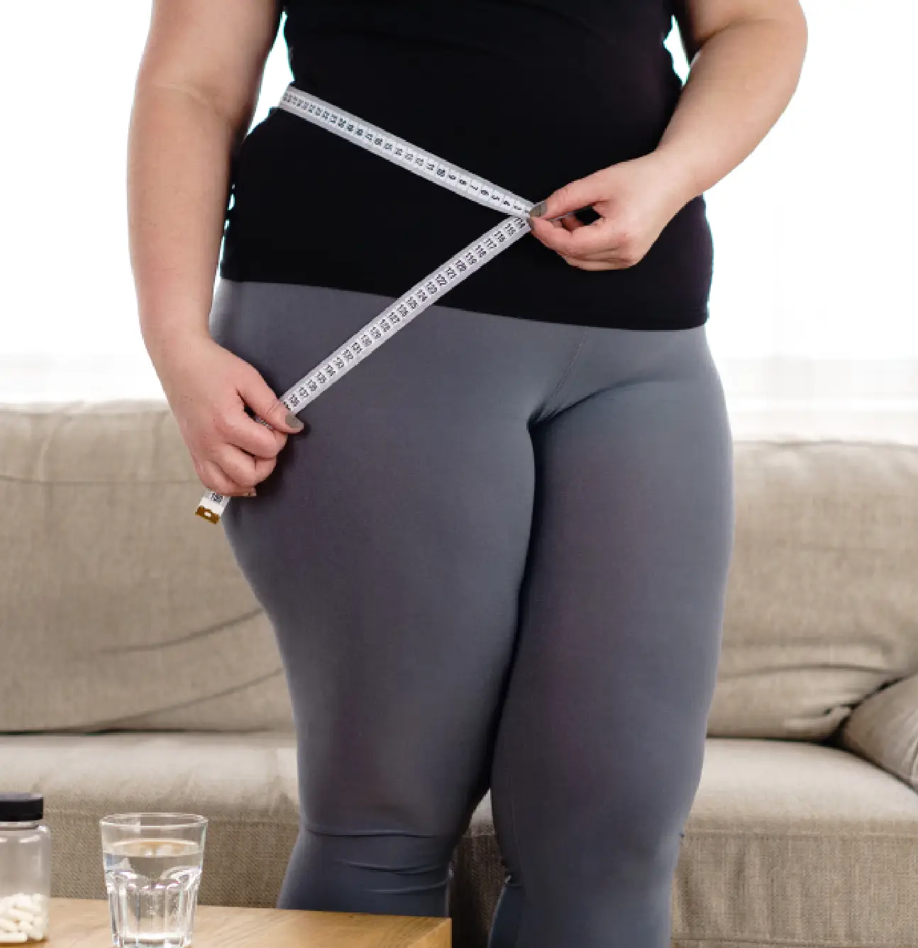 Measuring waistline in living room setting