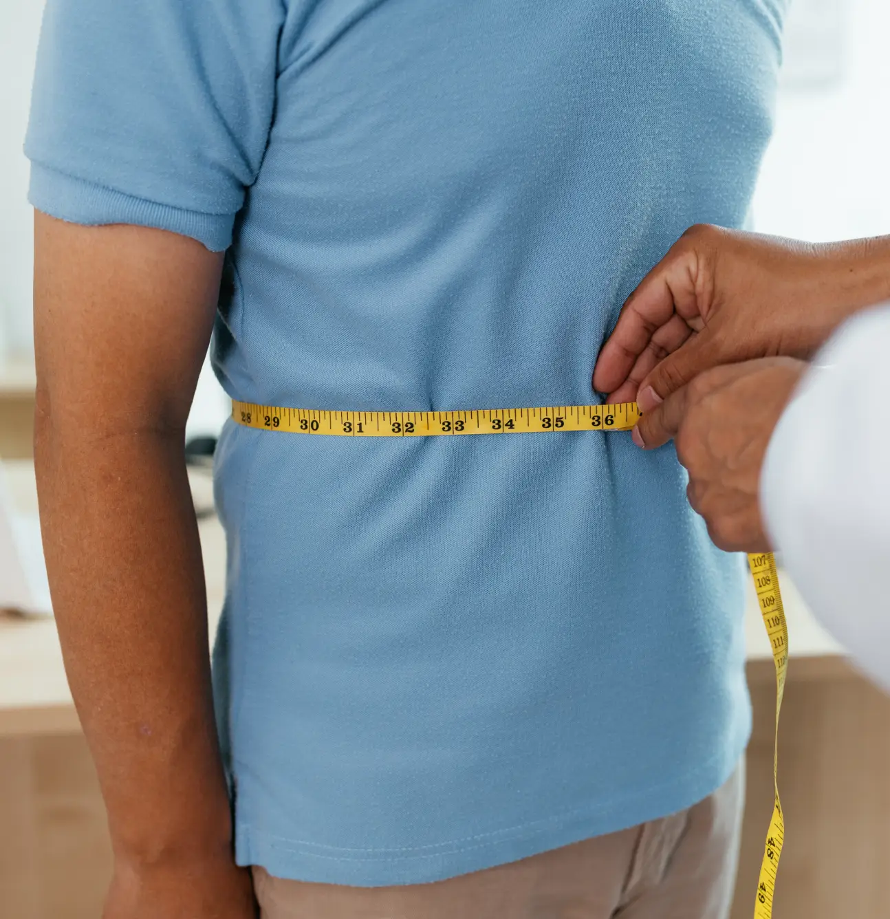 Person receiving waist measurement
