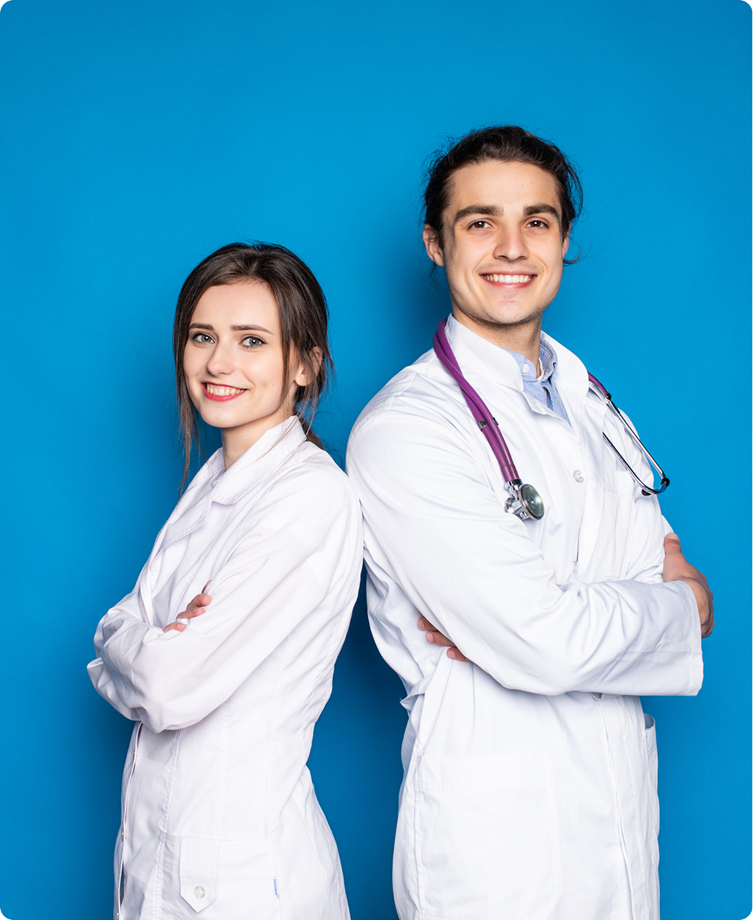 Doctors standing back to back smiling