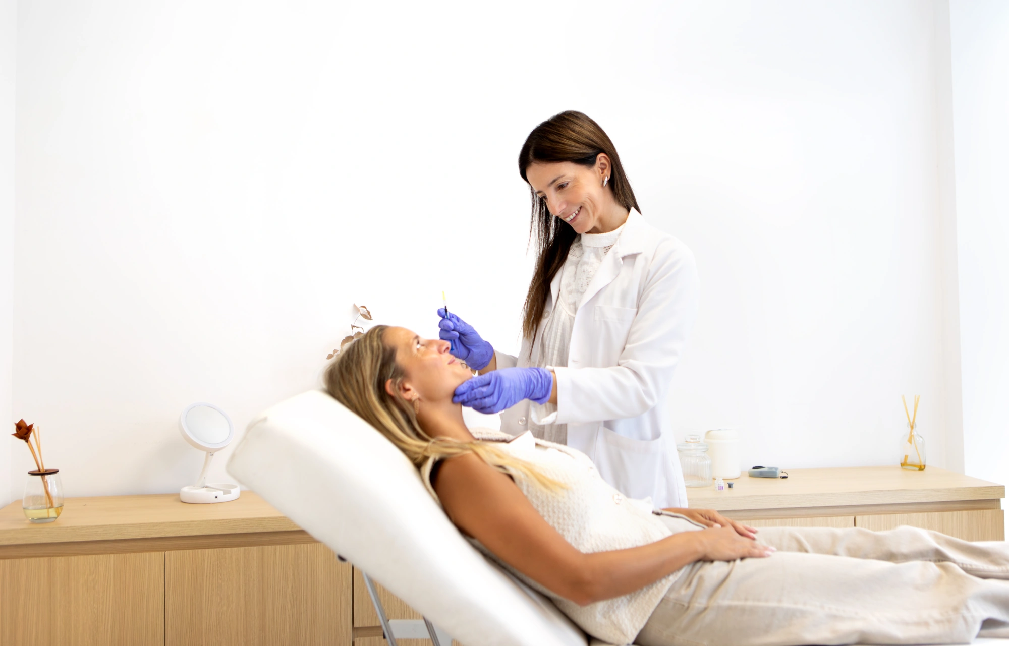 Cosmetic specialist treating patient in medical office
