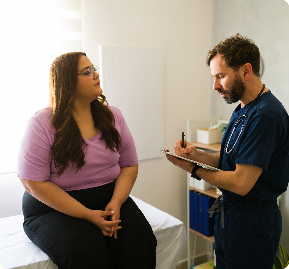 Medical professional taking notes during appointment