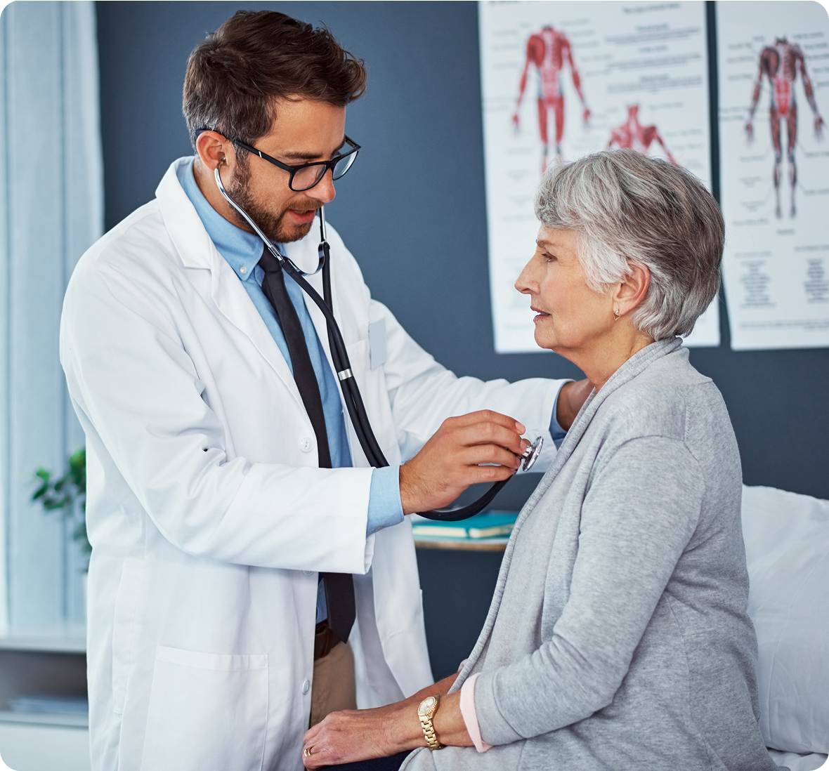 Doctor examining elderly patient with stethoscope
