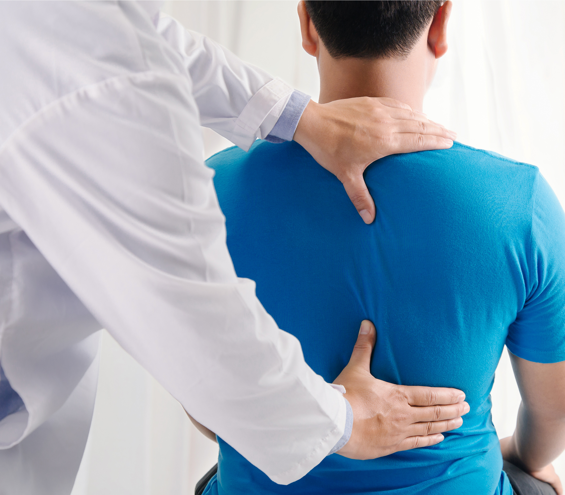 Doctor examining patient's back
