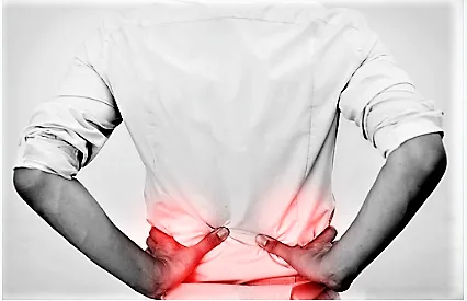 Person holding lower back in pain